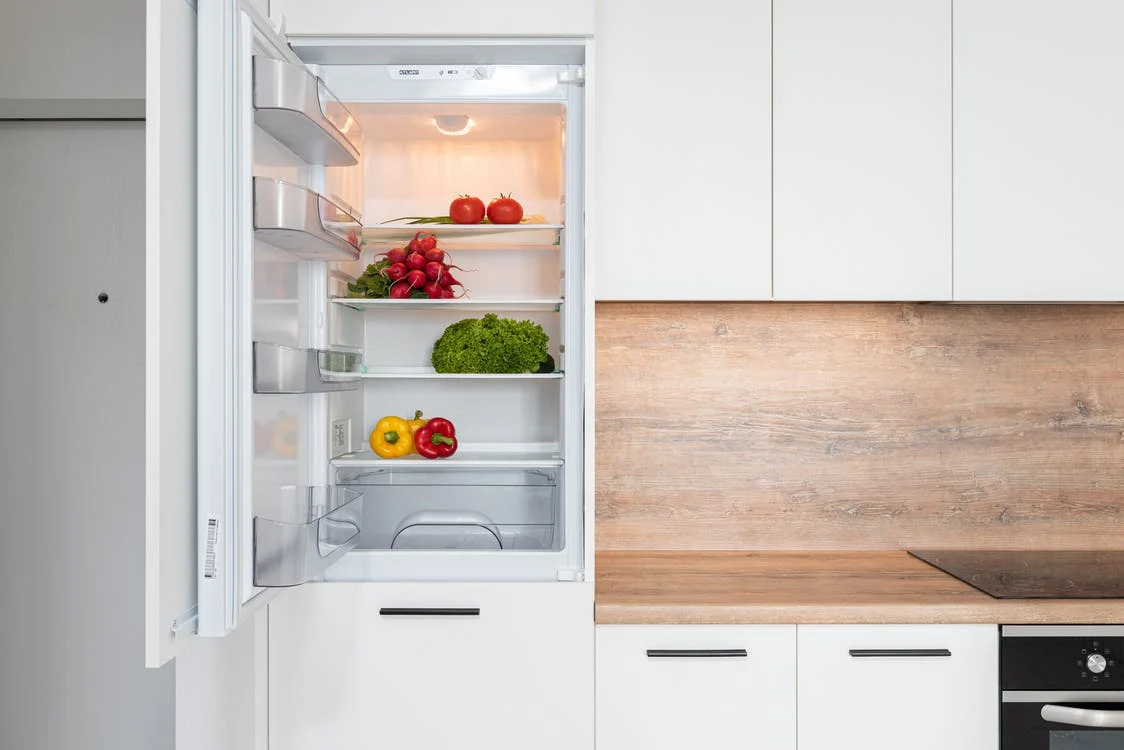 a refrigerator installed in a kitchen