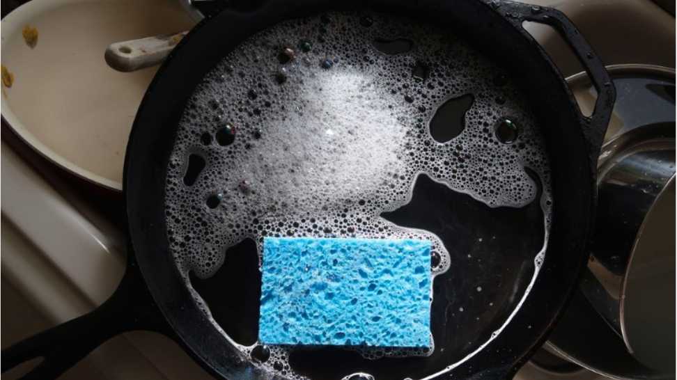 washing a cast iron skillet with soap and water