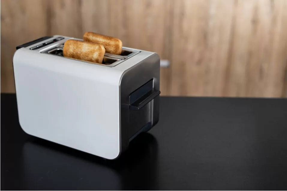 a white and silver colored popup toaster