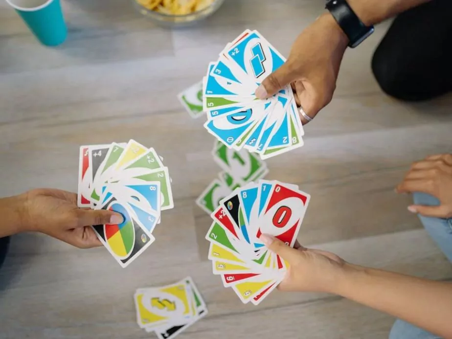 group of friends playing uno cards