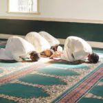 a group of muslim men performing fajr prayer