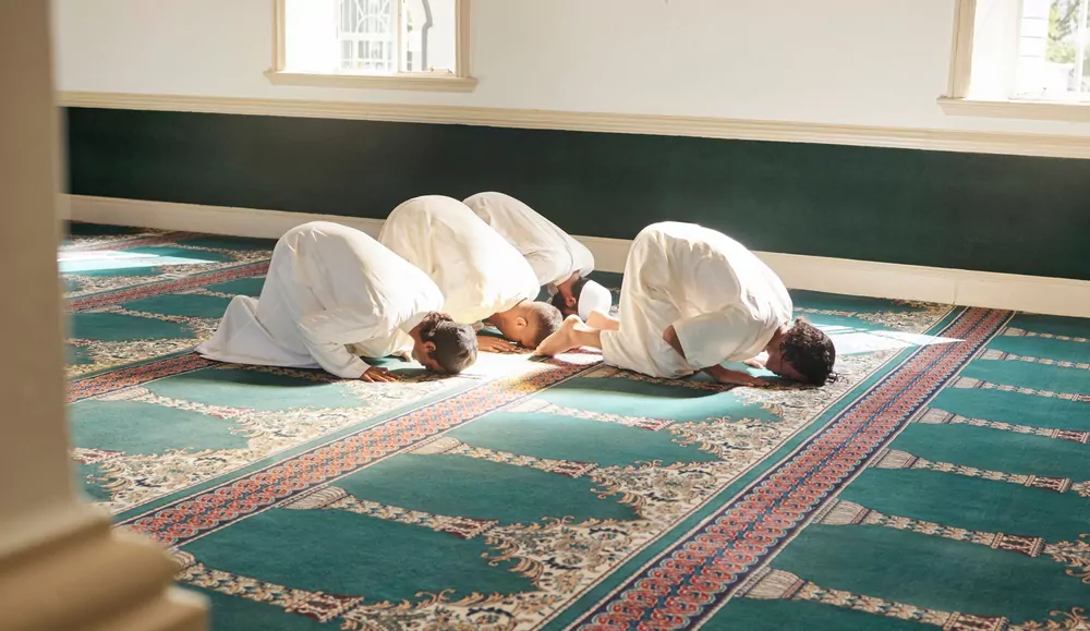 a group of muslim men performing fajr prayer