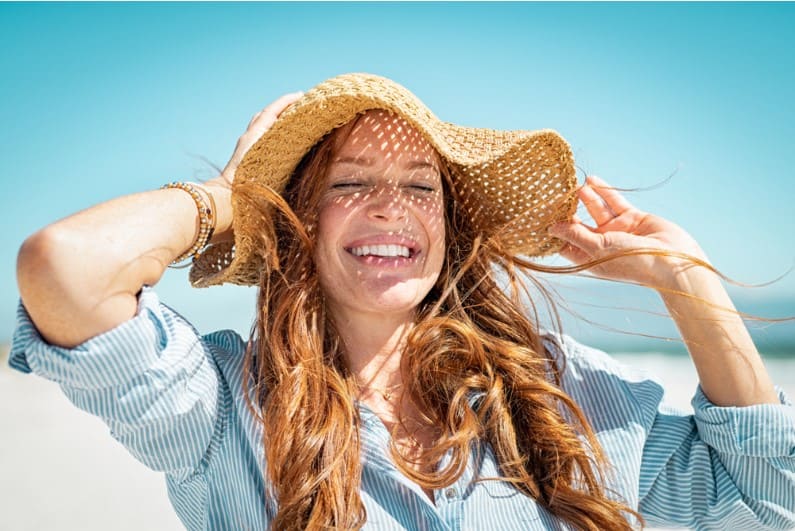 a woman wearing hat in sunlight