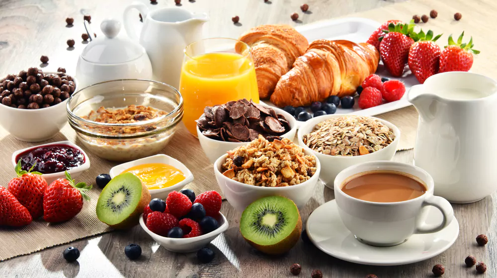 a table full of different foods for a balanced breakfast
