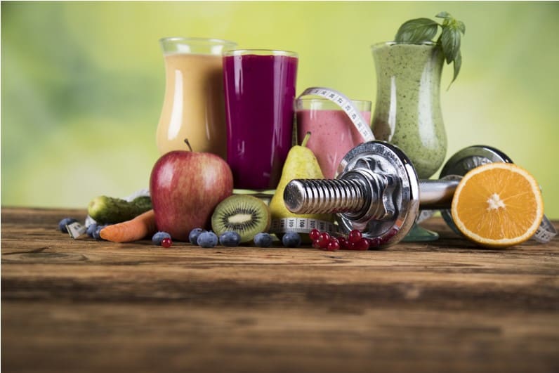glasses of healthy drinks and weights for healthy lifestyle