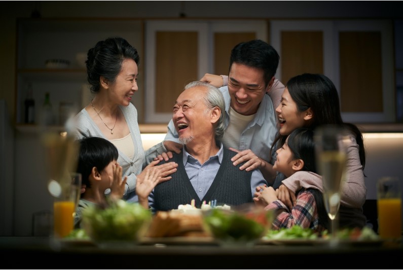 happy family celebrating grandpa's anniversary at home