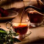 hot steaming black tea in a cup on a rustic background