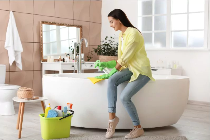 young woman cleaning bathroom