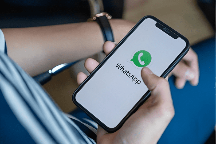 man holding iphone with whatsapp logo on cellphone screen
