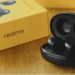 realme buds with box on a table