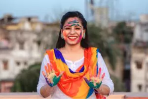woman celebrating holi with powder colours or gulal