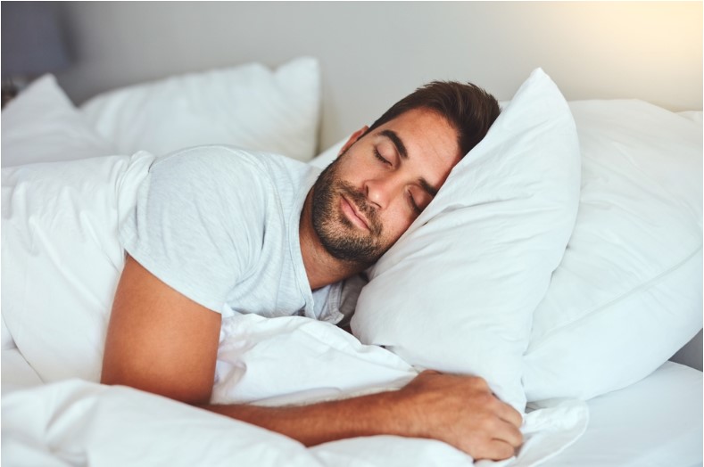 man sleeping peacefully on bed
