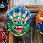 colorful wooden masks and handicrafts on sale at a shop in sikkim