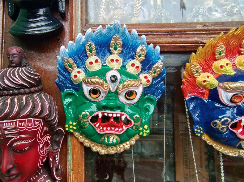colorful wooden masks and handicrafts on sale at a shop in sikkim