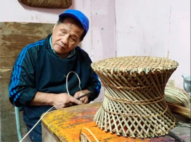 indian craftsman weaves a cane sitting stool for sale