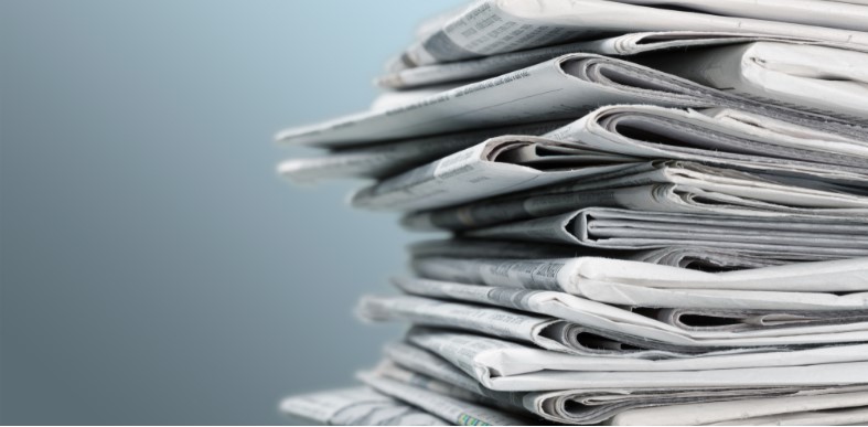 pile of newspapers on white background