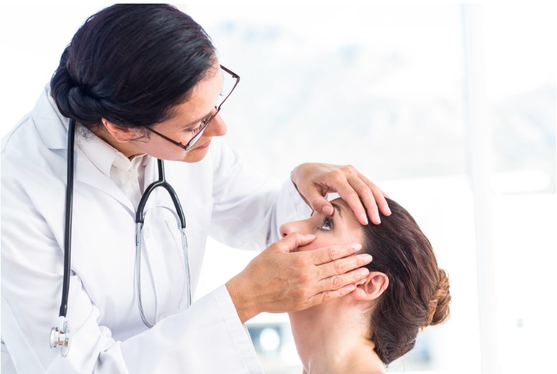 doctor checking her patients eyes in medical office