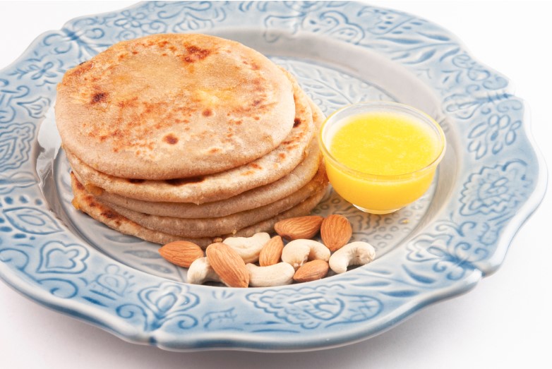 puran poli with ghee butter served in a plate