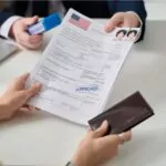 close-up of a woman getting a us visa in the immigration office and holding approved forms