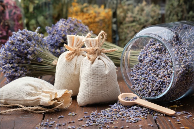 glass jar of dry lavender flowers sachets bunches of dry lavender