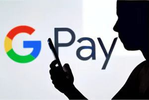the google pay logo is seen in the background of a woman holding a mobile phone