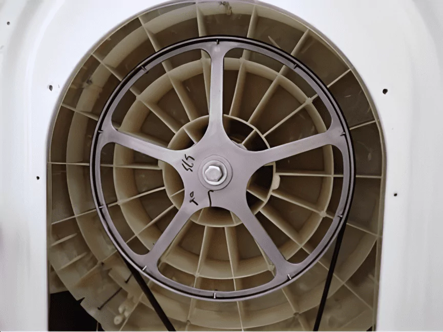 inside view of a broken washing machine focus on driving wheel