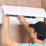 male technician service worker repairing air conditioner