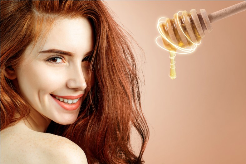 young redhead woman and honey spoon prepare for mask honey treatment concept