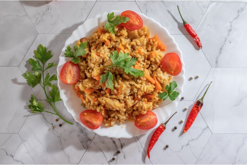 rice with tomatoes and hot peppers on a light background