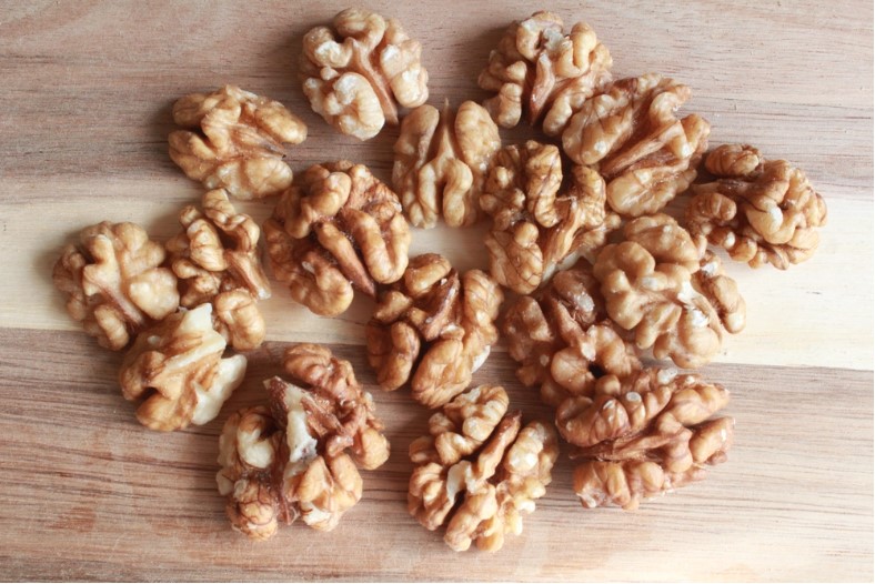 healthy shelled walnuts in a wooden table