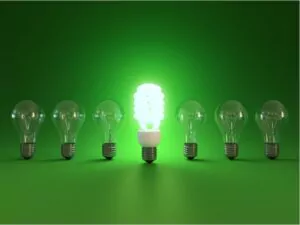 energy saving and simple light bulbs isolated on green background