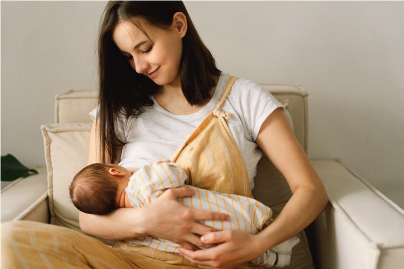 Portrait of mom and breastfeeding baby