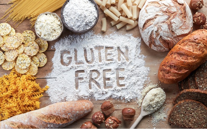 gluten free food various pasta bread snacks and flour on a wooden background from the top view