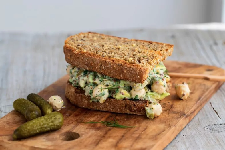 creamy chickpea salad with avocado dill onion and mustard sauce on home made bread