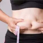 fat woman hand holding excessive belly fat with measuring tape healthcare and woman diet lifestyle concept to reduce belly and shape up healthy stomach muscle