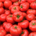 tomatoes lying on a pile on top of each other