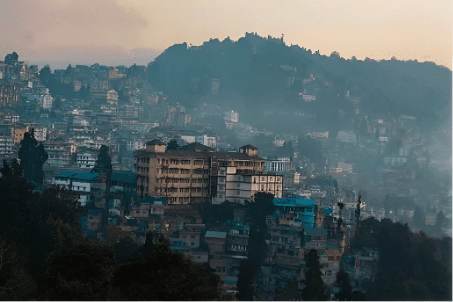 darjeeling city in the hills of north bengal covered in fog on chilly winter evening