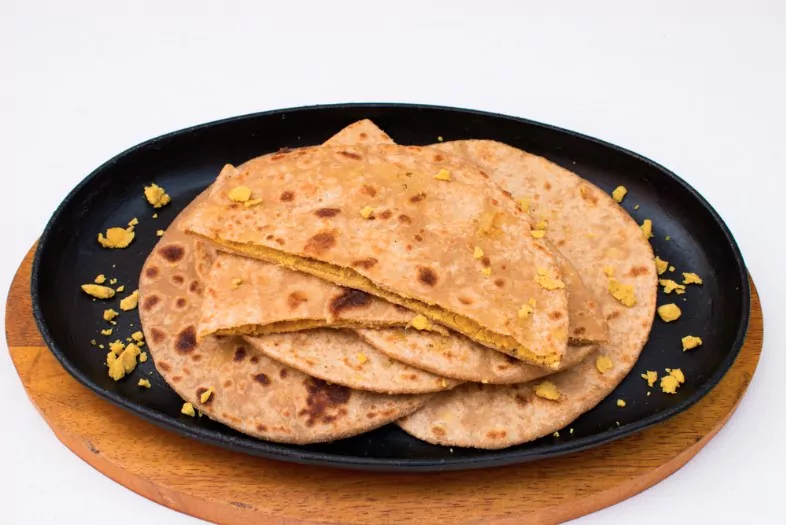 dal paratha or chana dal stuffed paratha in black plate in white background