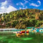 scenic beauty of lake surrounded by mountains and trees doon valley mussoorie