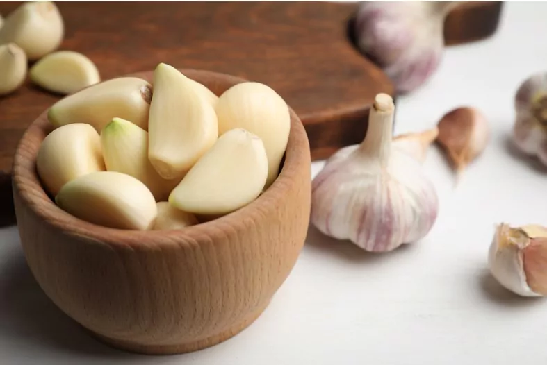fresh organic garlic on white table