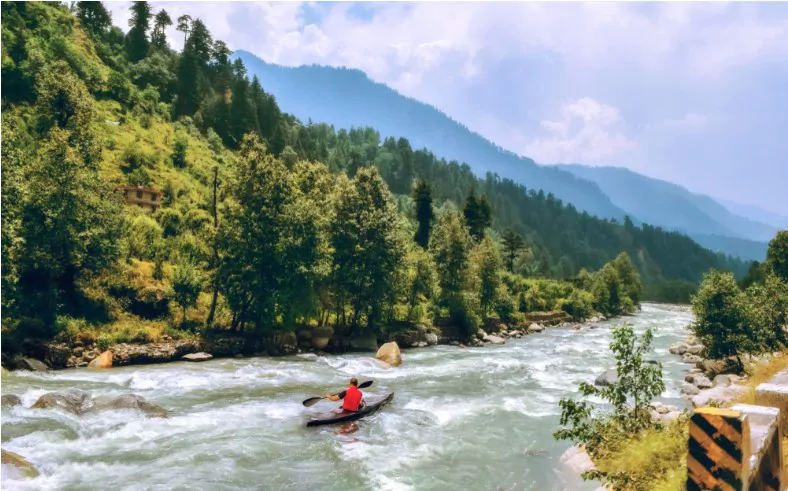 tourist enjoy river rafting on beas river with scenic landscape at manali himachal pradesh in summer