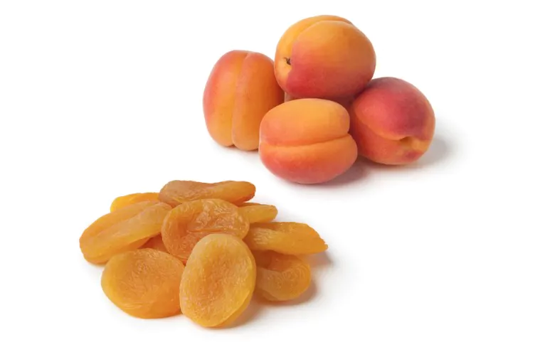 heap of healthy nutritious fresh and dried apricot fruit on white background