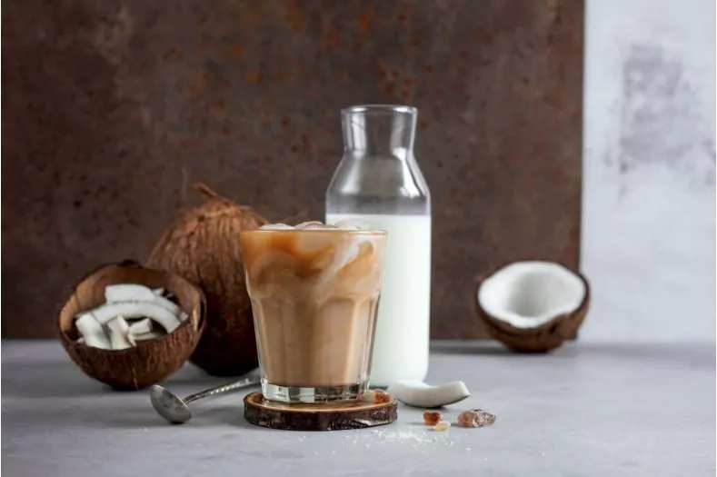 coffee with coconut milk on brown background