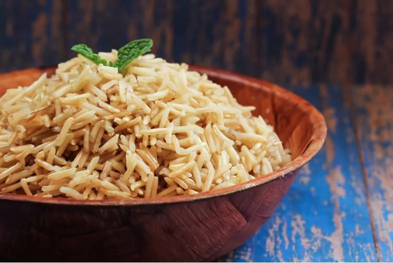 cooked brown basmati rice in a wooden bowl
