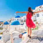 carefree girl tourist in european destination wearing red fashion dress
