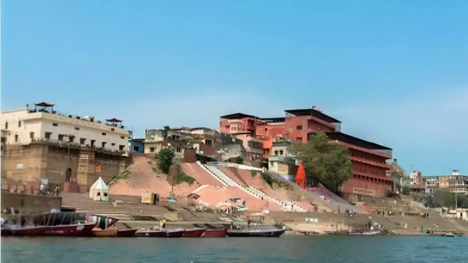 wide angle picture of the beautiful architecture of shivala ghat in front of ganges river in the city of varanasi