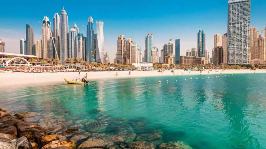 luxurious and spectacular sandy beach with vacationers in the dubai marina and jbr area