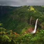 nohkalikai waterfalls flanked by deep gorge with forested slopes under overcast sky near shillong