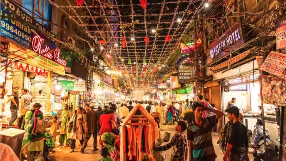 people in urdu bazar or market street of historical part of chandni chowk locality of old delhi in the evening