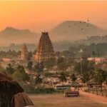 historic virupaksha temple with scenic hampi landscape and cityscape at sunset at karnataka india